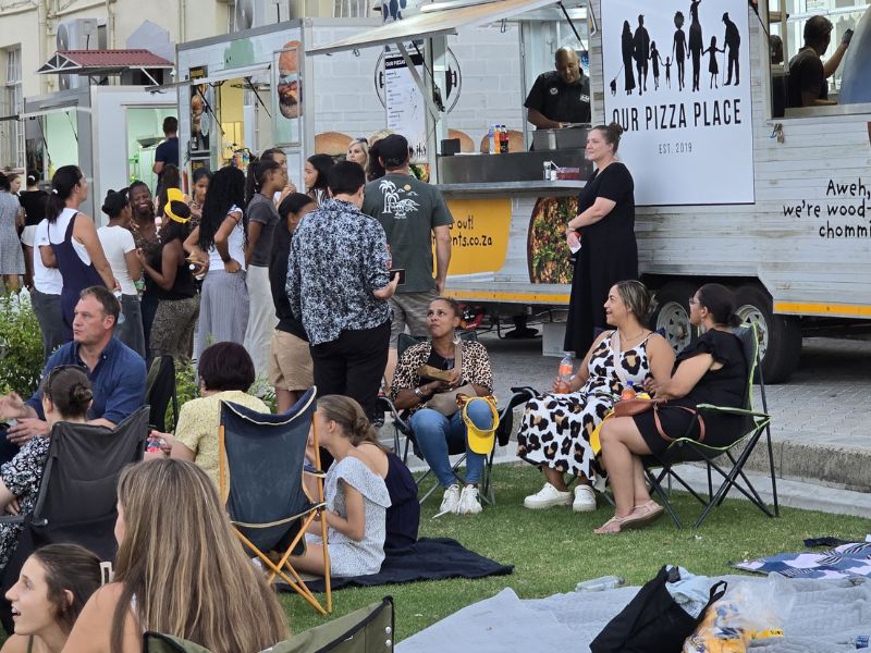 Group of people in front of Our Pizza Place Food Truck making Woodfired Pizza