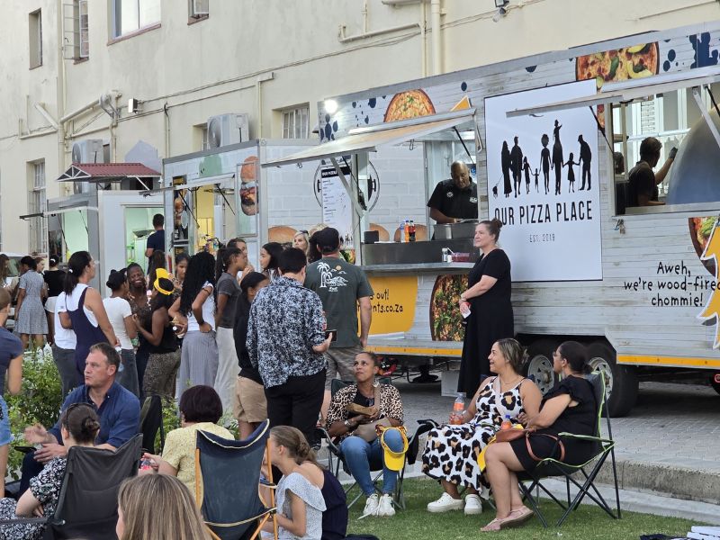 Group of people infront of Our Pizza Place Food Truck making WOodfired Pizza